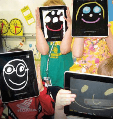 Four children using tablets to draw faces