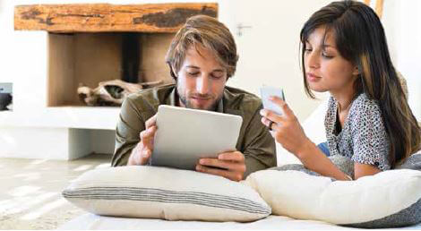 Man and woman holding mobile devices