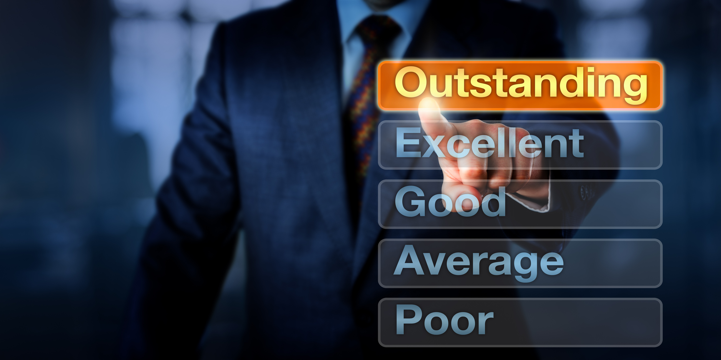 Man pointing to the word outstanding in a list including excellent, good, average, and poor